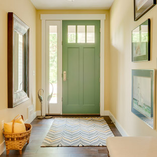 Mid-sized arts and crafts medium tone wood floor entryway photo in Grand Rapids with yellow walls and a green front door