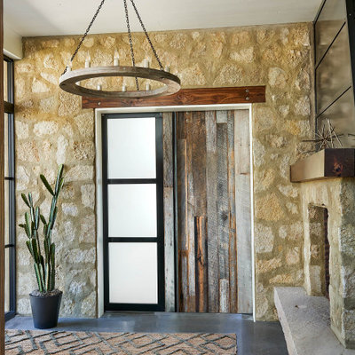Example of a large cottage concrete floor and gray floor entryway design in Denver with a medium wood front door