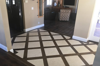 Entryway - mid-sized transitional laminate floor entryway idea in Los Angeles with beige walls and a dark wood front door