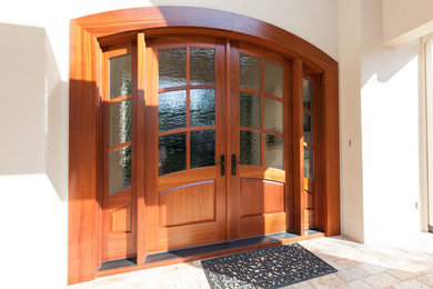 Medium sized contemporary front door in Miami with beige walls, travertine flooring, a double front door and a medium wood front door.