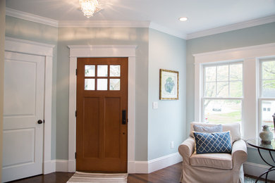 Inspiration for a mid-sized transitional dark wood floor and brown floor entryway remodel in Boston with blue walls and a medium wood front door