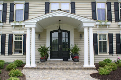 This is an example of a classic front door in Chicago with a double front door and a black front door.