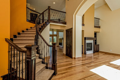 Inspiration for a large classic foyer in Denver with orange walls and medium hardwood flooring.