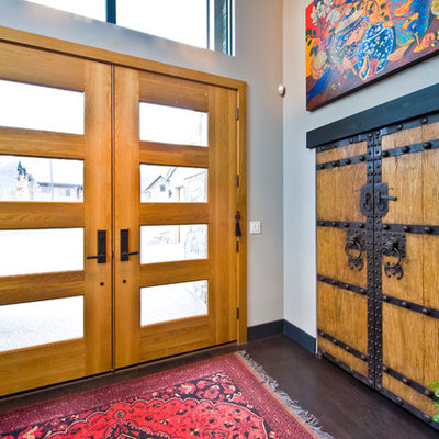 Inspiration for a contemporary entryway remodel in Calgary with a glass front door