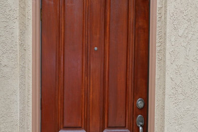 Inspiration for a southwestern entryway remodel in San Diego with a dark wood front door