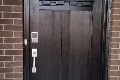 Entryway - mid-sized craftsman dark wood floor entryway idea in Chicago with beige walls and a black front door