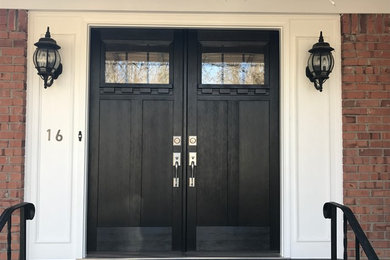 Example of an arts and crafts double front door design in New York with a black front door