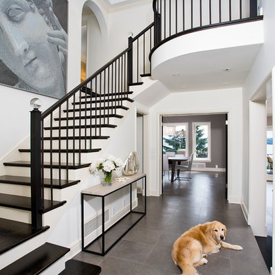Inspiration for a timeless gray floor entryway remodel in Seattle with a black front door