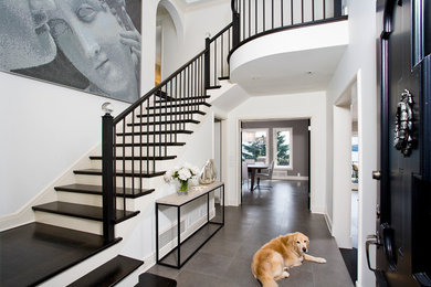 Inspiration for a timeless gray floor entryway remodel in Seattle with a black front door