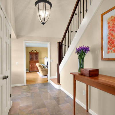 Elegant slate floor foyer photo in Seattle with beige walls