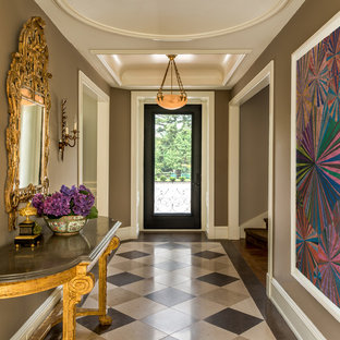 Idée de décoration pour une grand entrée tradition avec un couloir, un mur marron, une porte simple, une porte en verre et un sol multicolore.