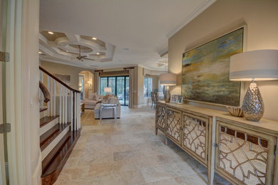 Inspiration for a large transitional travertine floor and beige floor entryway remodel in Orlando with beige walls