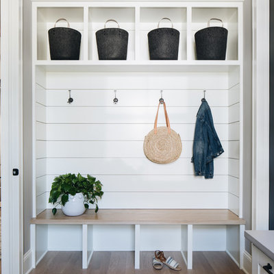 Mudroom - country medium tone wood floor and brown floor mudroom idea in Chicago with gray walls