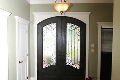 Example of a large dark wood floor entryway design in Austin with a dark wood front door