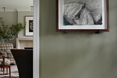 Example of a mid-sized transitional dark wood floor entryway design in DC Metro with green walls and a black front door