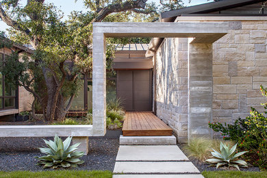 Example of a mid-sized transitional entryway design in Austin with a brown front door