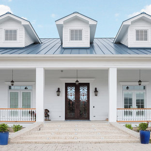 Entryway - country entryway idea in Other with white walls and a brown front door