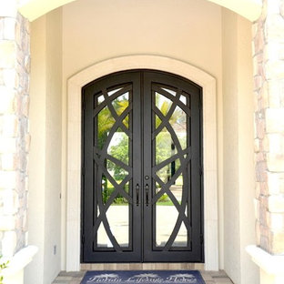 Large tuscan entryway photo in Tampa with a metal front door