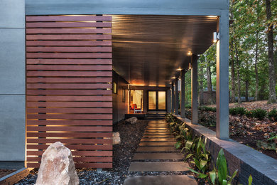 Entryway - mid-sized contemporary slate floor entryway idea in Other with gray walls and a gray front door