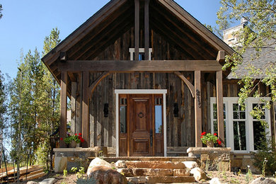 Inspiration for a rustic entryway remodel in Denver with a dark wood front door