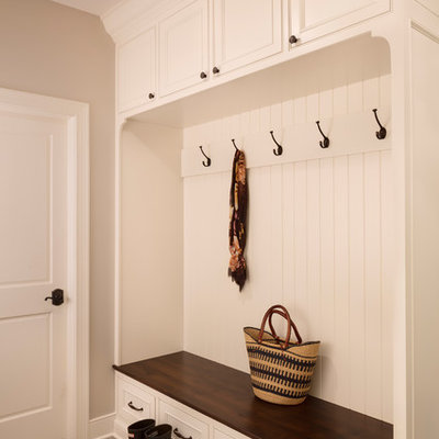 Entryway - mid-sized cottage ceramic tile and beige floor entryway idea in Milwaukee with beige walls and a white front door
