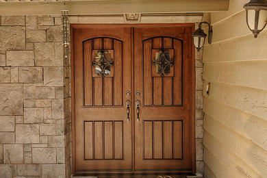 Inspiration for a huge rustic entryway remodel in Orange County with brown walls and a medium wood front door