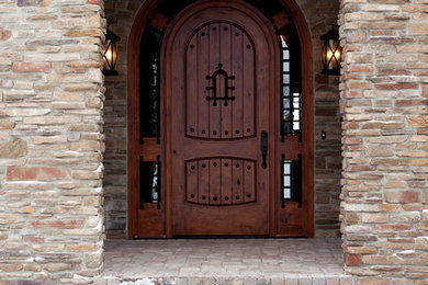 Mountain style entryway photo in Milwaukee with a dark wood front door