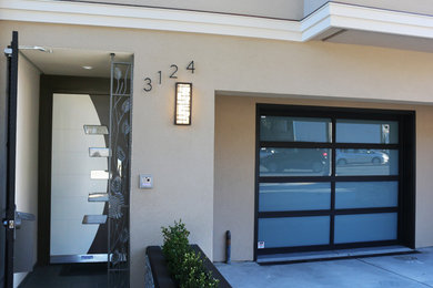 Inspiration for a small contemporary porcelain tile and gray floor entryway remodel in San Francisco with white walls and a white front door