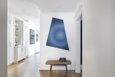 Small transitional medium tone wood floor entryway photo in San Francisco with white walls