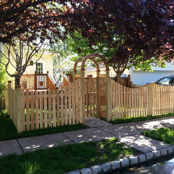 Scalloped Spaced board fence with Red Cedar Arbor