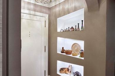 Example of a small transitional medium tone wood floor and brown floor entryway design with gray walls and a white front door