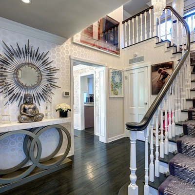 Trendy painted wood floor entryway photo in Los Angeles with multicolored walls and a white front door