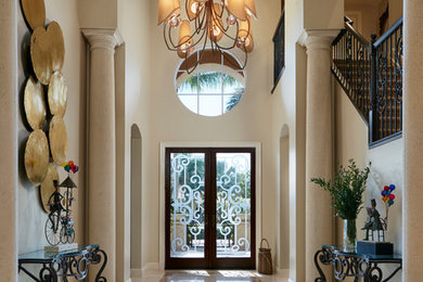 Example of a large transitional porcelain tile entryway design in Miami with beige walls and a dark wood front door