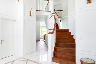 Example of a trendy marble floor foyer design in Vancouver with white walls