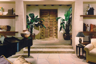 Example of a large southwest slate floor entryway design in Santa Barbara with beige walls and a medium wood front door