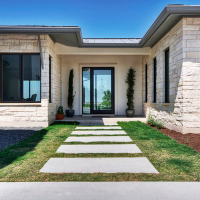 Example of a trendy entryway design in Austin with a glass front door