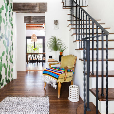 Example of a tuscan medium tone wood floor and brown floor entry hall design in Sacramento with white walls