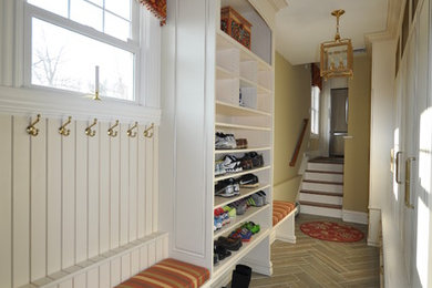 Example of a mid-sized classic ceramic tile mudroom design in Newark with beige walls