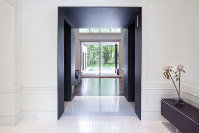 Entryway - large modern marble floor and white floor entryway idea in Toronto with white walls
