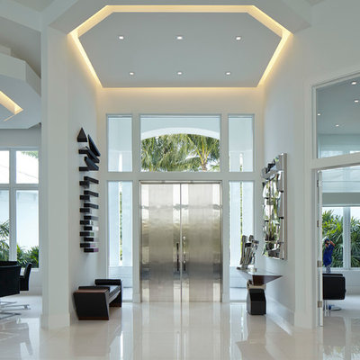 Trendy porcelain tile entryway photo in Miami with white walls and a metal front door