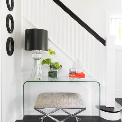 Mid-sized transitional porcelain tile and black floor foyer photo in Toronto with white walls