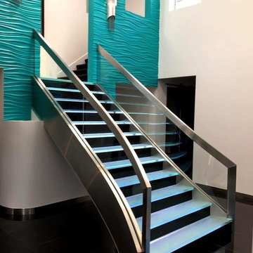Stainless Staircase with bent glass and LED backlit glass steps