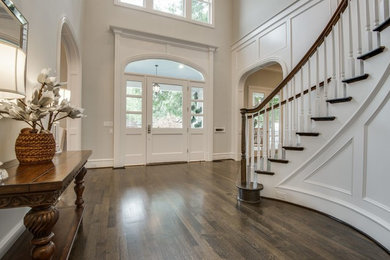 Large elegant dark wood floor and brown floor entryway photo in Dallas with beige walls and a white front door