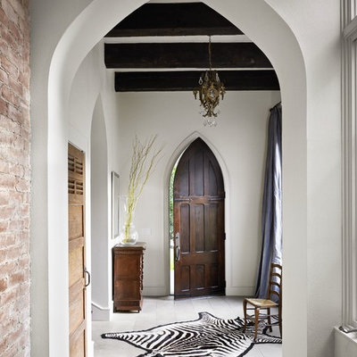 Eclectic white floor entryway photo in Austin with white walls and a dark wood front door