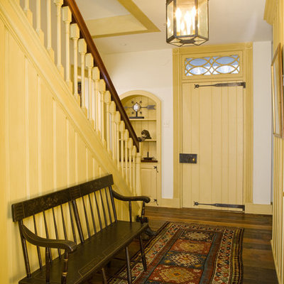 Mid-sized cottage medium tone wood floor entryway photo in Philadelphia with white walls and a yellow front door