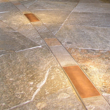 Stone, Copper and Stainless Steel floor detail mimics the soffit above