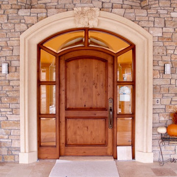 Stone door surround with an ornamented keystone.