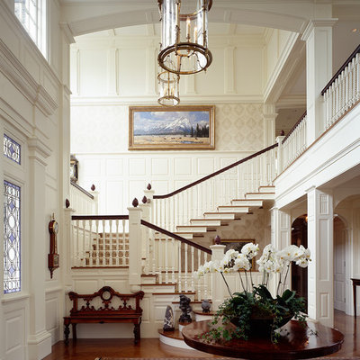 Example of a classic dark wood floor foyer design in Boston with white walls