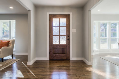 Inspiration for a large timeless dark wood floor and brown floor entryway remodel in Dallas with gray walls and a dark wood front door