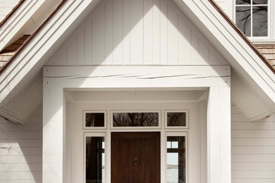 Inspiration for a large transitional entryway remodel in Minneapolis with a dark wood front door